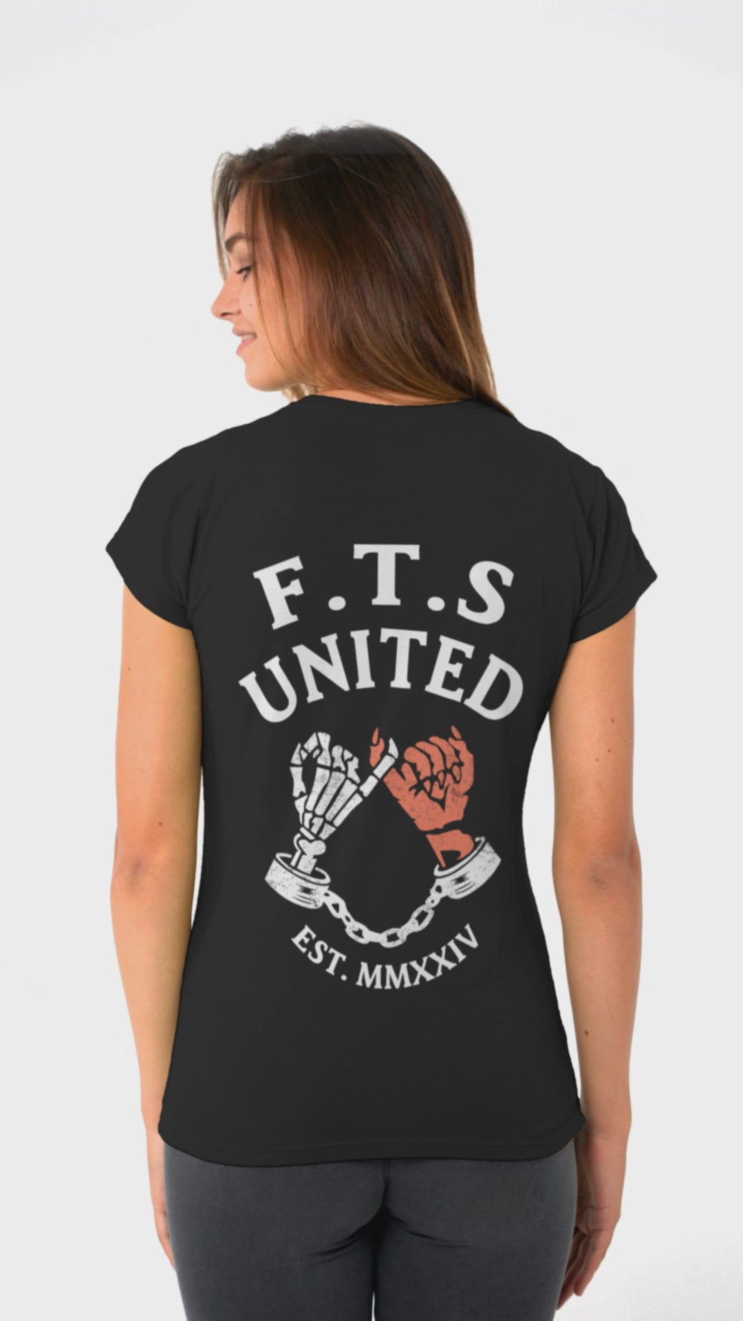 Black Tshirt with a skeleton hand and a devils hand doing a pinky promise. On the top is F.T.S United which stands for "Fuck this Shit United" established in Melbourne in 2024.