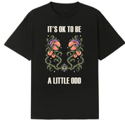 A black oversized tee with the It's OK To Be A Little Odd graphic printed large on the front.