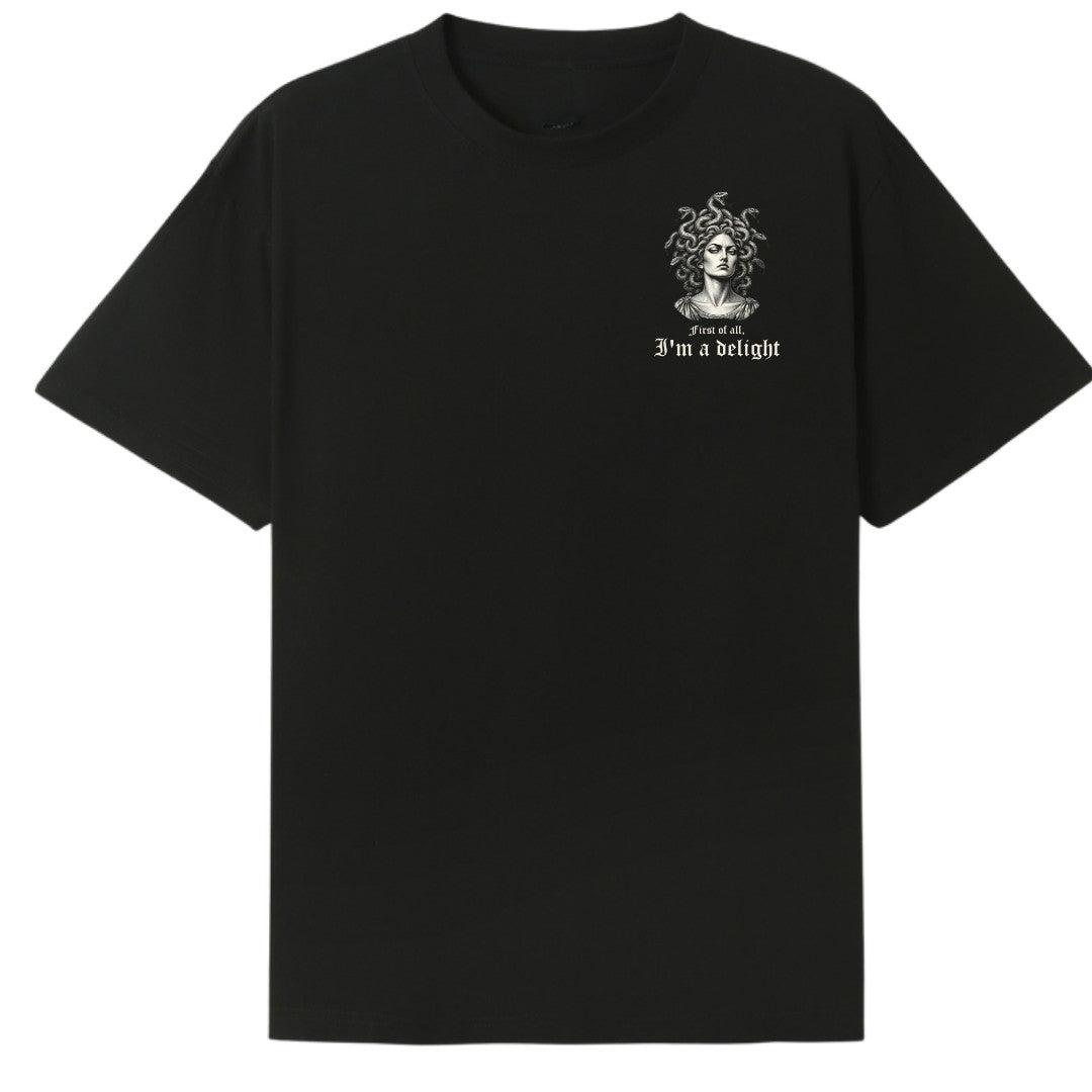A black oversized tee with a small First Of All I'm A Delight graphic on the left chest.