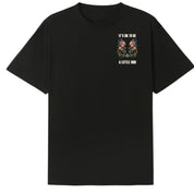 A black oversized tee with a small It's OK To Be A Little Odd graphic on the left chest.