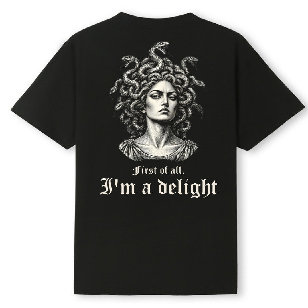 A black oversized tee shown from the back, with the First Of All I'm A Delight graphic printed large across the back.