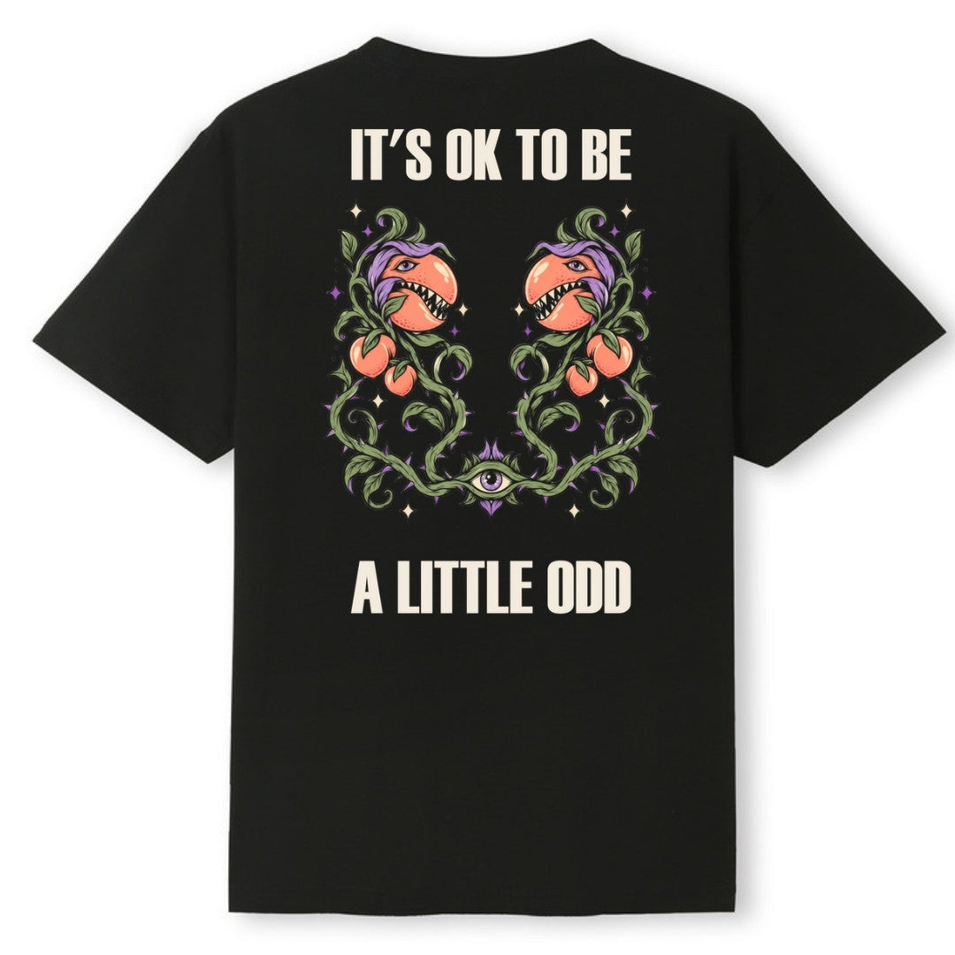 A black oversized tee shown from the back, with the It's OK To Be A Little Odd graphic printed large across the back.