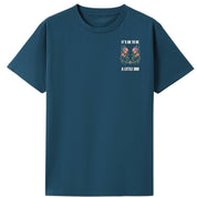 A teal oversized tee with a small It's OK To Be A Little Odd graphic on the left chest.