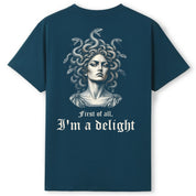 A teal oversized tee shown from the back, with the First Of All I'm A Delight graphic printed large across the back.