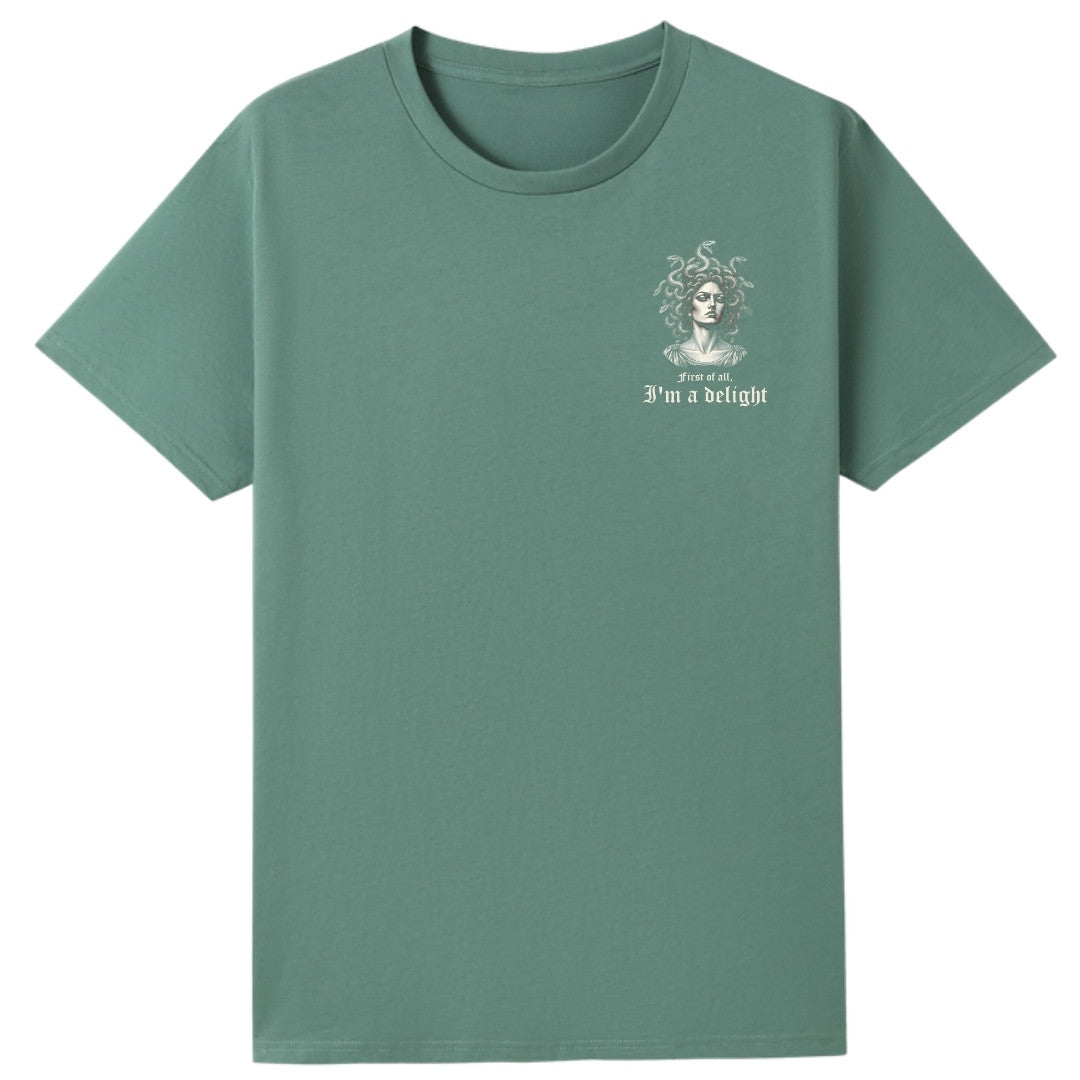 A slate green oversized tee with a small First Of All I'm A Delight graphic on the left chest.
