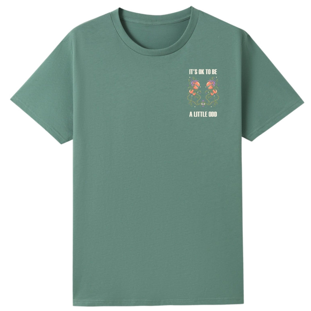 A slate green oversized tee with a small It's OK To Be A Little Odd graphic on the left chest.