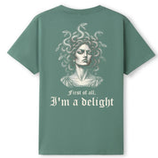 A slate green oversized tee shown from the back, with the First Of All I'm A Delight graphic printed large across the back.