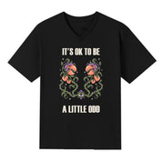A black V-neck oversized tee with the It's OK To Be A Little Odd graphic printed large on the front.