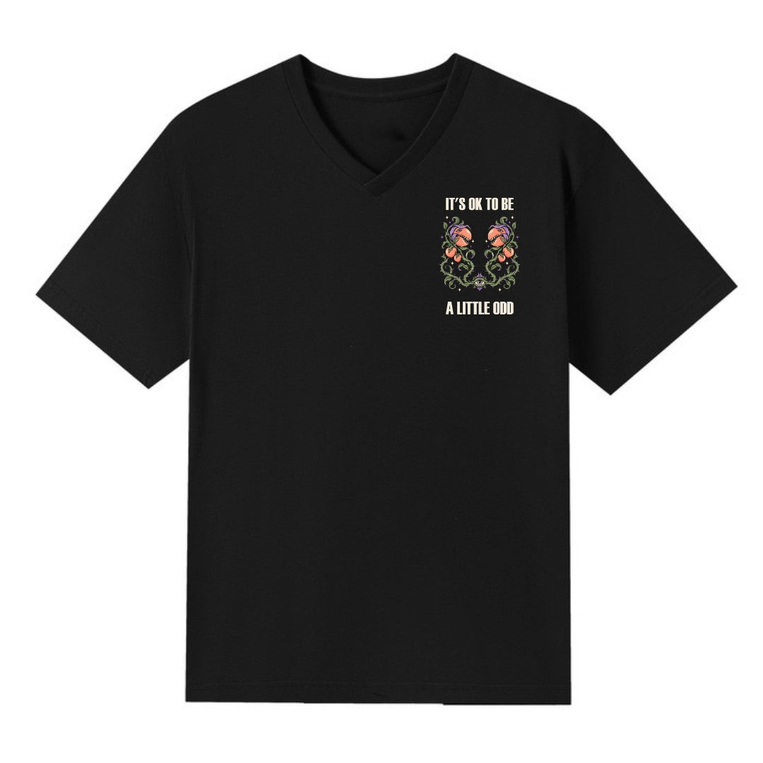 A black V-neck oversized tee with a small It's OK To Be A Little Odd graphic on the left chest.