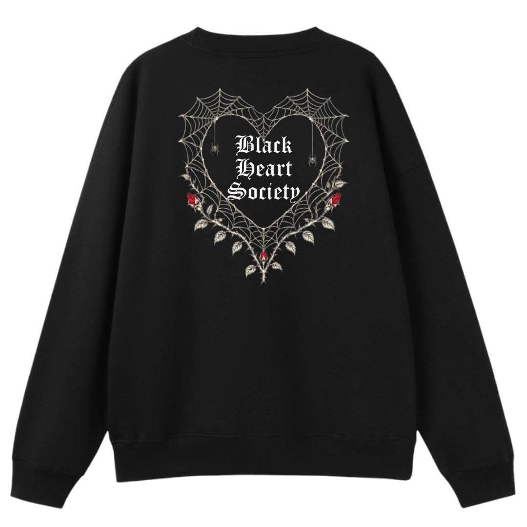 A black oversized crew neck shown from the back, with the Black Heart Society graphic printed large across the back.