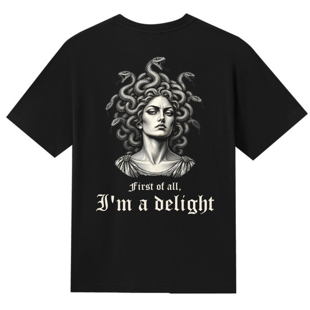 A black V-neck oversized tee shown from the back, with the First Of All I'm A Delight graphic printed large across the back.