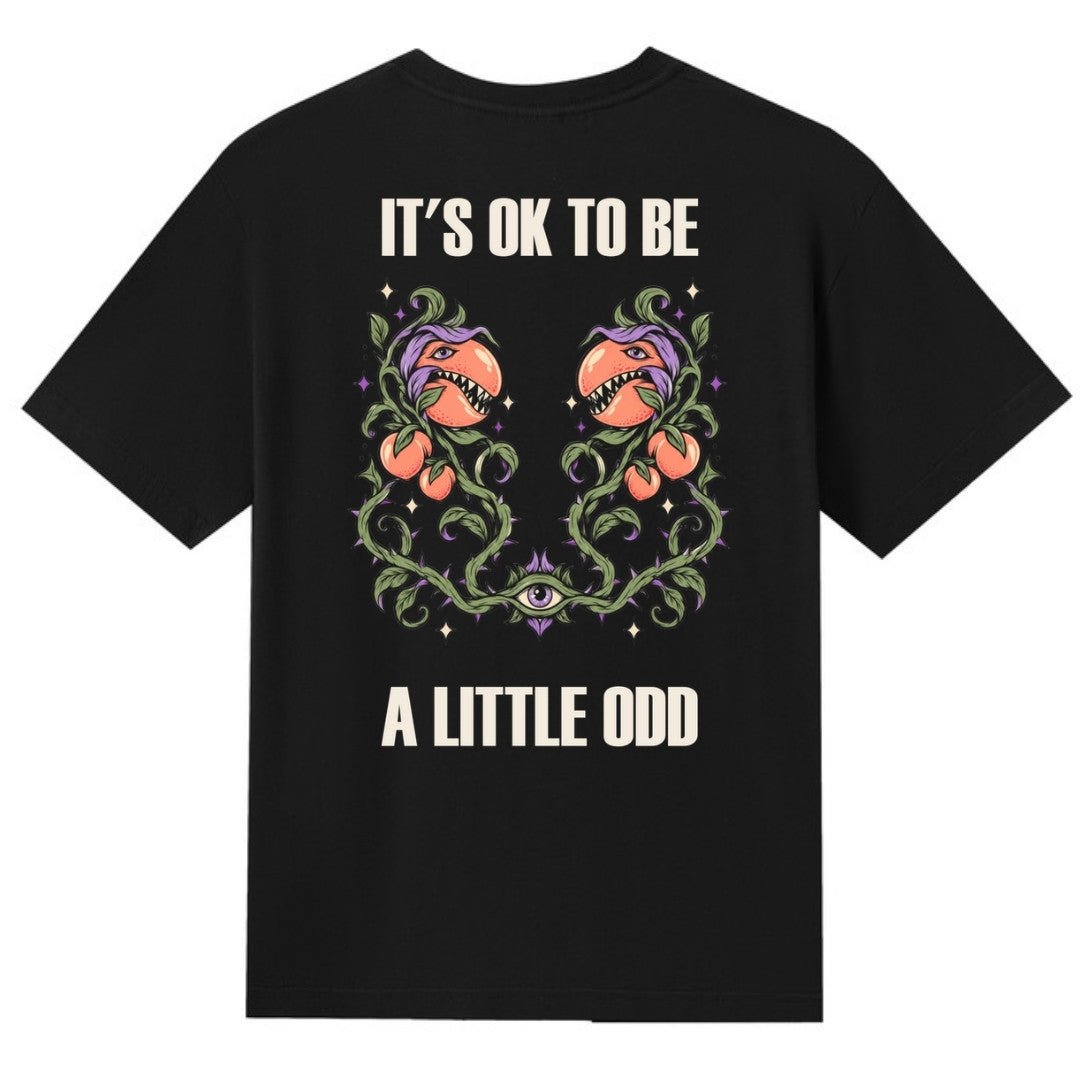 A black V-neck oversized tee shown from the back, with the It's OK To Be A Little Odd graphic printed large across the back.