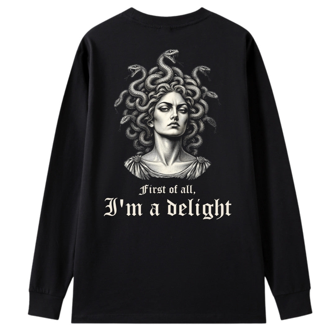 A black oversized long sleeve tee shown from the back, with the First Of All I'm A Delight graphic printed large across the back.