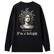 A black oversized long sleeve tee shown from the back, with the First Of All I'm A Delight graphic printed large across the back.