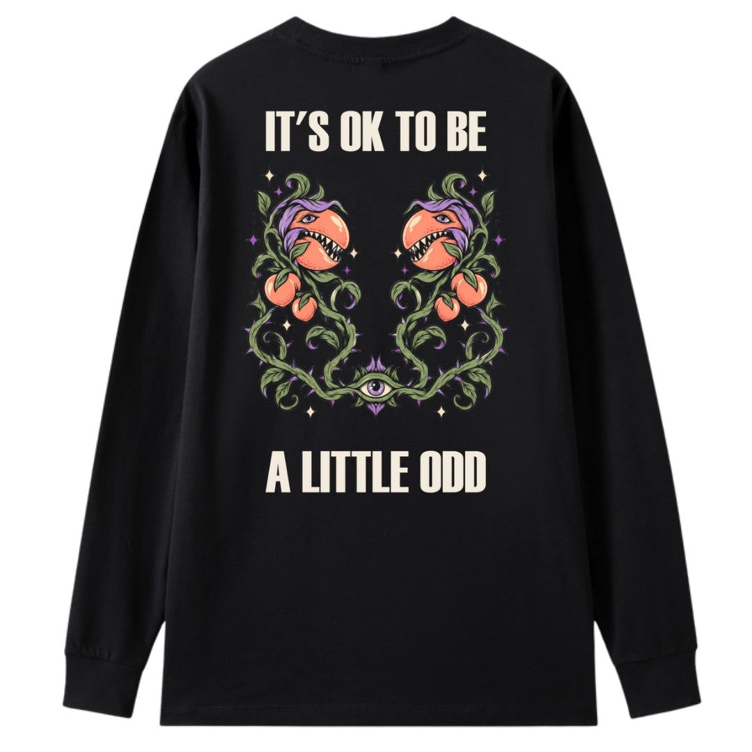 A black oversized long sleeve tee shown from the back, with the It's OK To Be A Little Odd graphic printed large across the back.