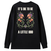 A black oversized long sleeve tee shown from the back, with the It's OK To Be A Little Odd graphic printed large across the back.