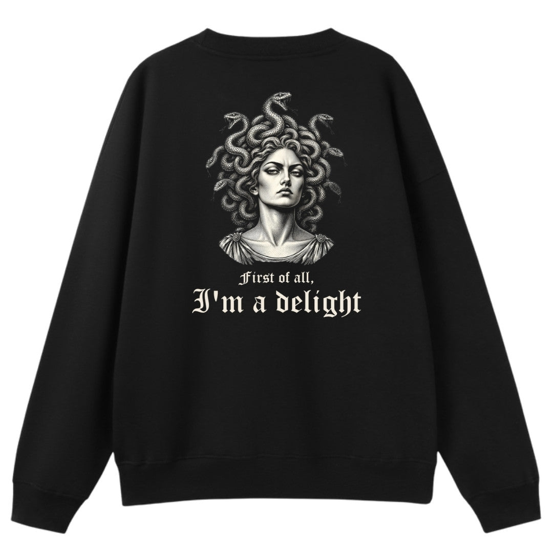 A black oversized crew neck shown from the back, with the First Of All I'm A Delight graphic printed large across the back.
