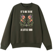 A army green oversized crew neck with the It's OK To Be A Little Odd graphic printed large on the front.