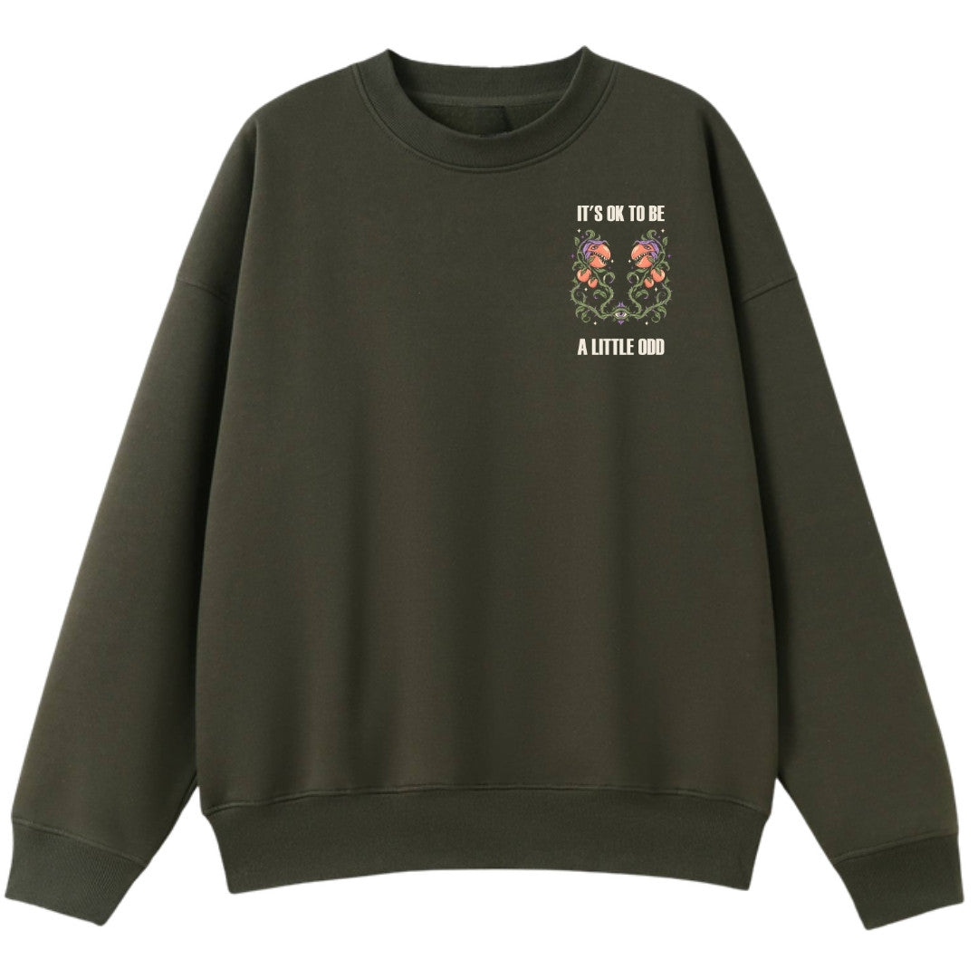 A army green oversized crew neck with a small It's OK To Be A Little Odd graphic on the left chest.