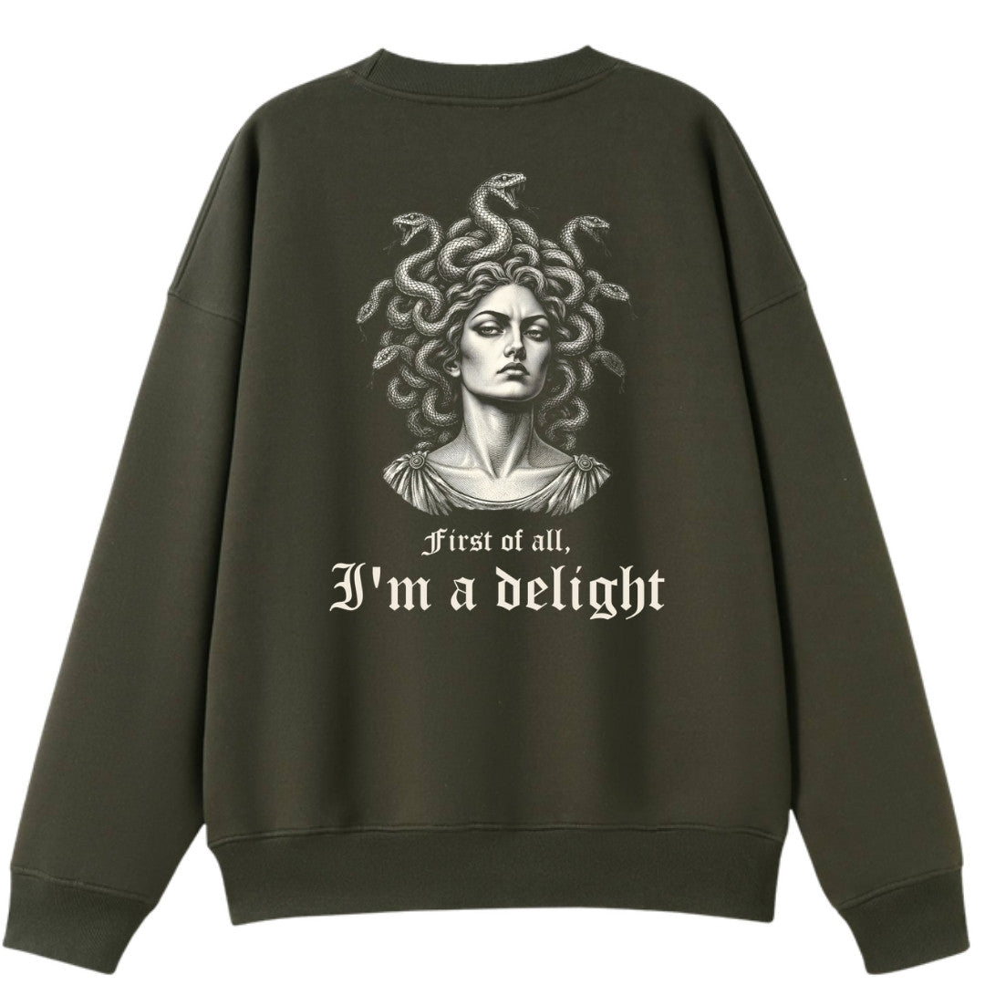 A army green oversized crew neck shown from the back, with the First Of All I'm A Delight graphic printed large across the back.