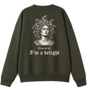A army green oversized crew neck shown from the back, with the First Of All I'm A Delight graphic printed large across the back.