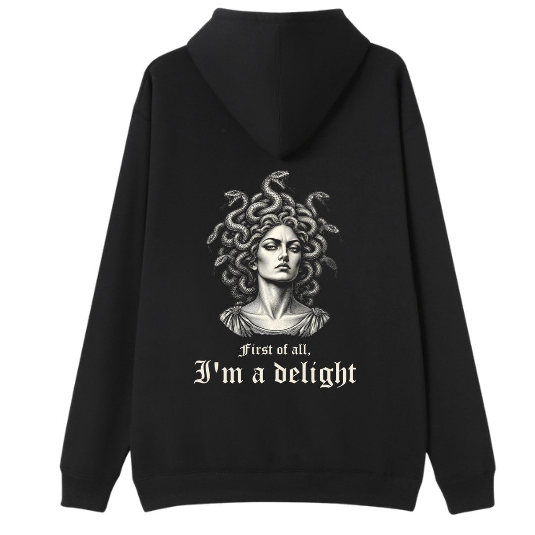 A black oversized hoodie shown from the back, with the First Of All I'm A Delight graphic printed large across the back.