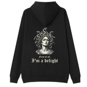A black oversized hoodie shown from the back, with the First Of All I'm A Delight graphic printed large across the back.
