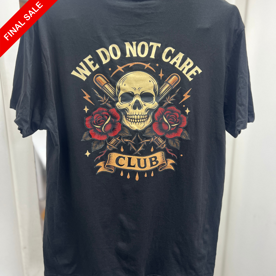 Black t-shirt with skull and roses design and 'We Do Not Care Club' text on a white background.