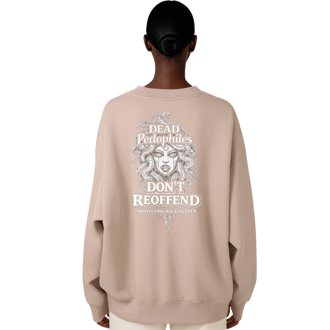 A person shown from the back wearing an oversized light beige sweatshirt with a large white graphic print on the back. The graphic features a Medusa-style illustration and the text 'Dead Pedophiles Don't Reoffend' and 'Protecting All Children.