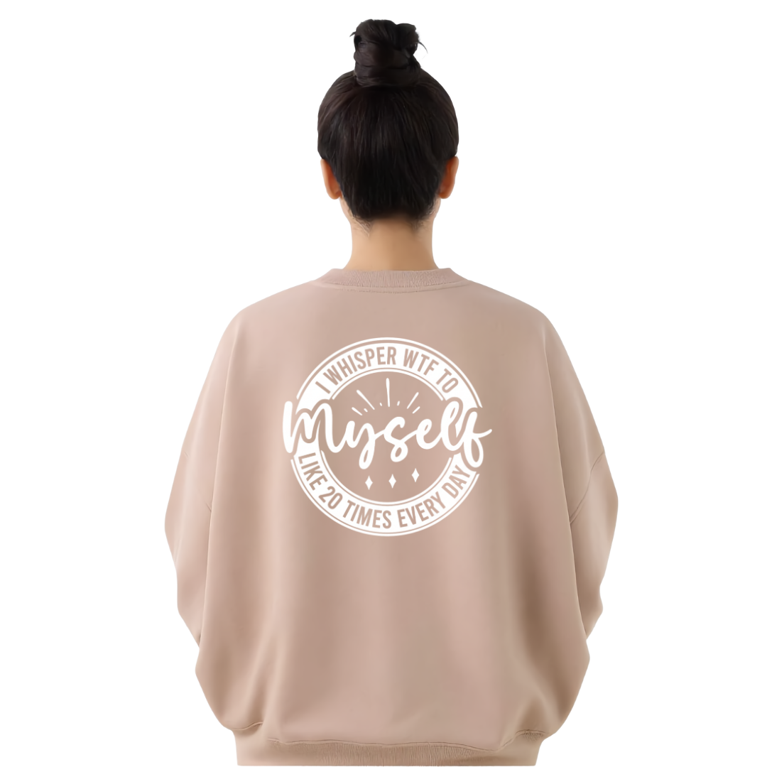 A woman viewed from behind wearing a light beige crewneck sweatshirt with a white circular graphic on the back that reads 'WHISPER WTF TO myself LIVE 20 TIMES EVERY DAY'.