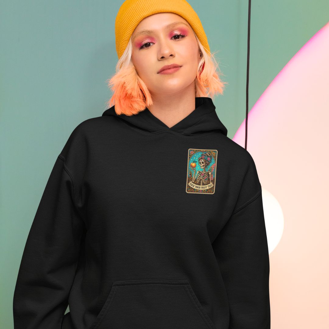 Person wearing a black hoodie with a colorful patch on a gradient background