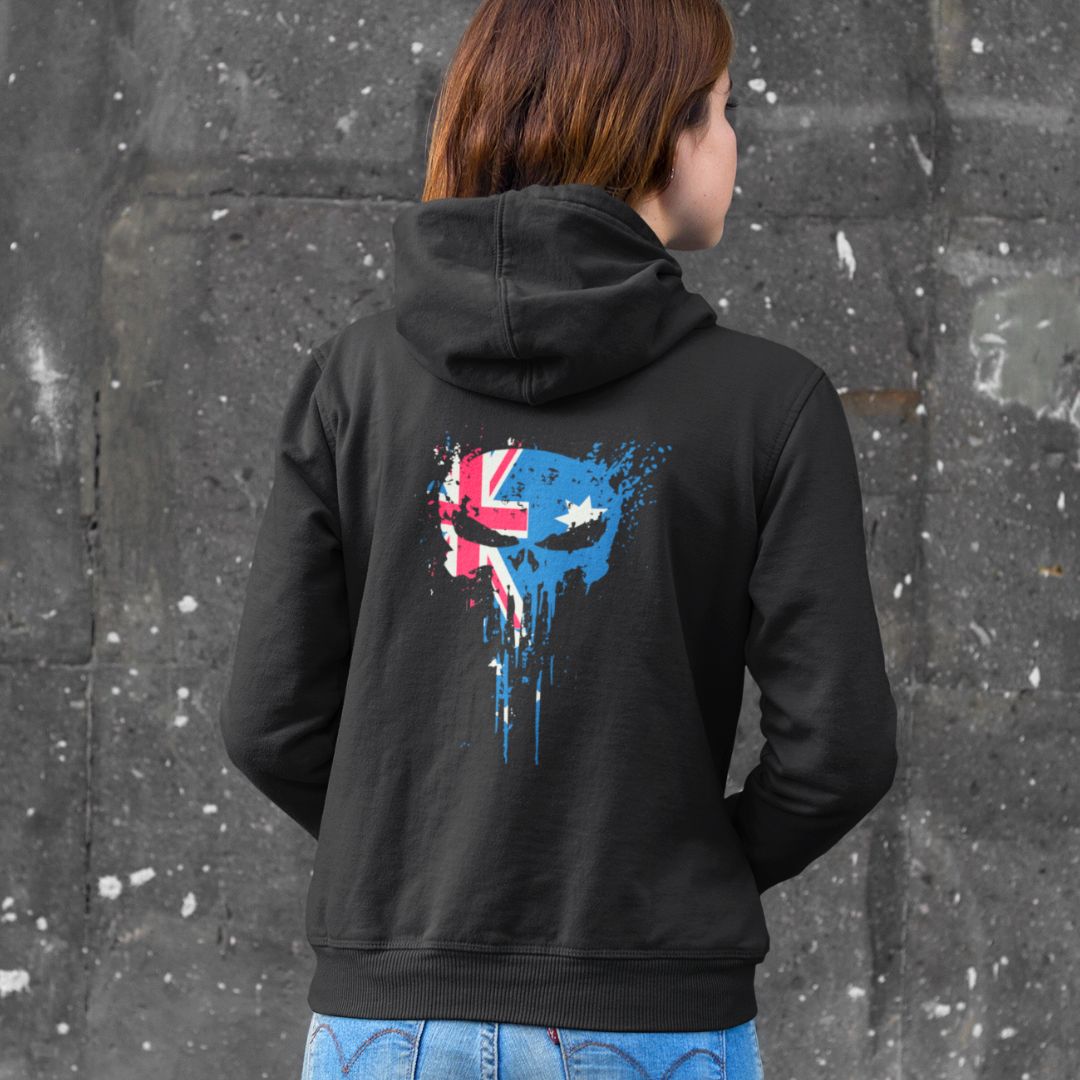 Person wearing a black hoodie with a colorful graphic design on the back against a gray wall.