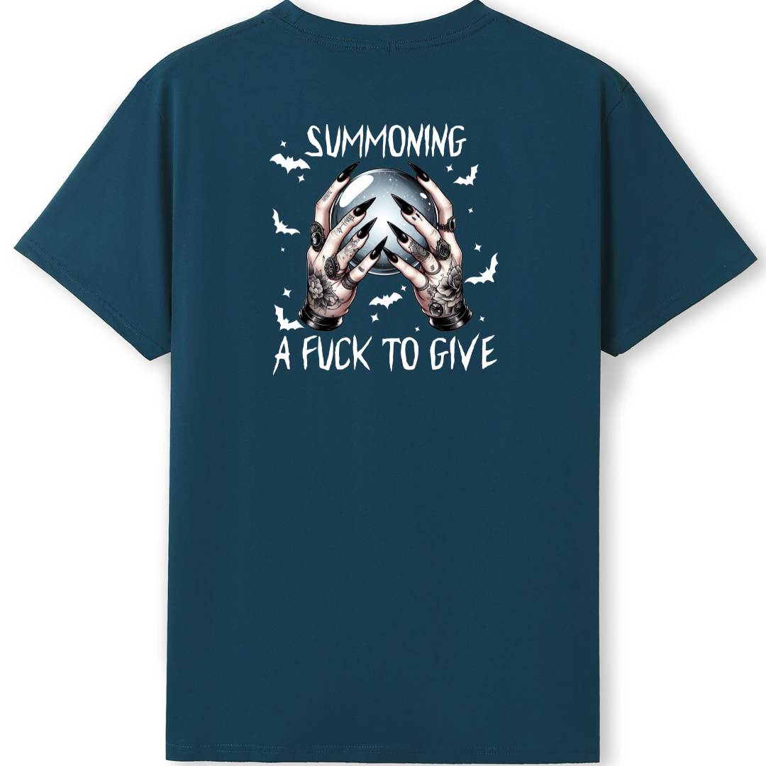 A dark teal blue short-sleeve t-shirt shown from the back, featuring a graphic print of two skeletal hands holding a skull with the text 'SUMMONING A FUCK TO GIVE' and small white bats.