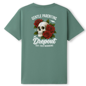 A sage green short-sleeve t-shirt shown from the back, featuring a graphic print of a skull surrounded by red roses and the text 'GENTLE PARENTING The Dropout EST. THIS MORNING'.