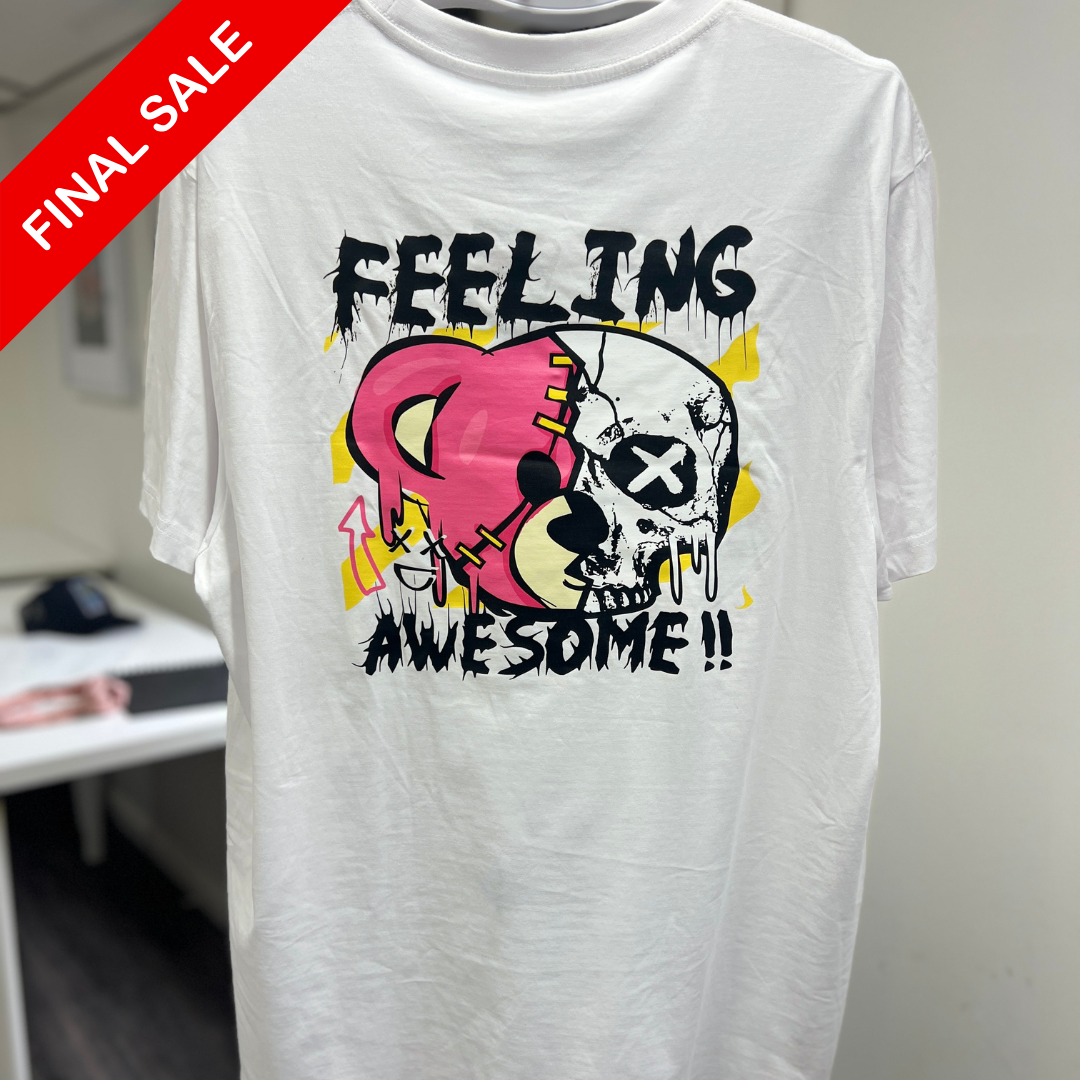 White t-shirt with colorful graphic design and 'Feeling Awesome!' text, displayed indoors.
