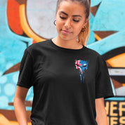 Person wearing a black t-shirt with a graphic design in front of a colorful mural.