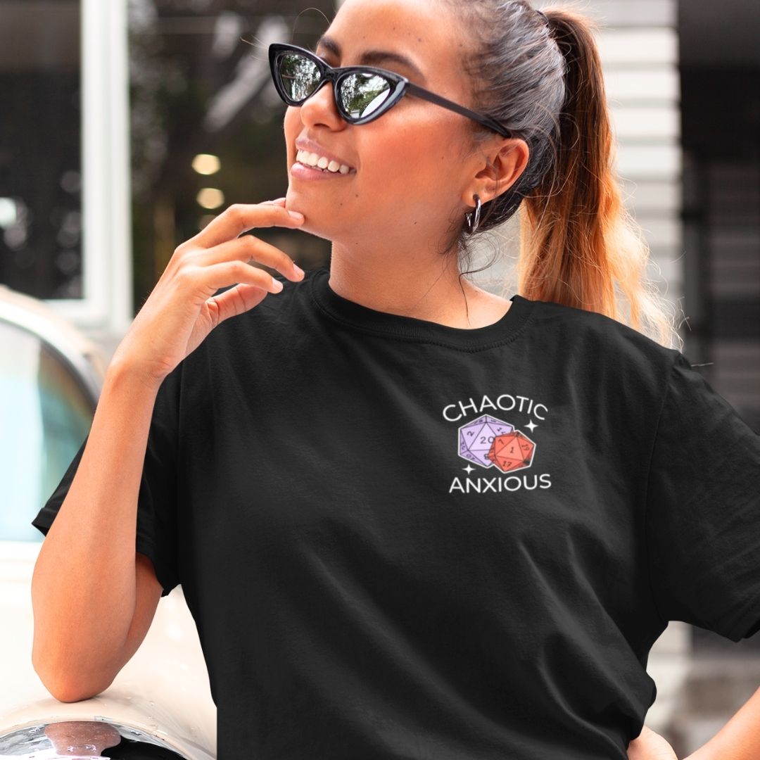 Woman wearing a black t-shirt with 'Chaotic Anxious' design outdoors.