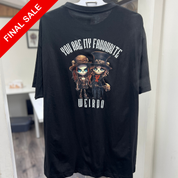 Black t-shirt with cartoon characters and text on a hanger against a white wall.