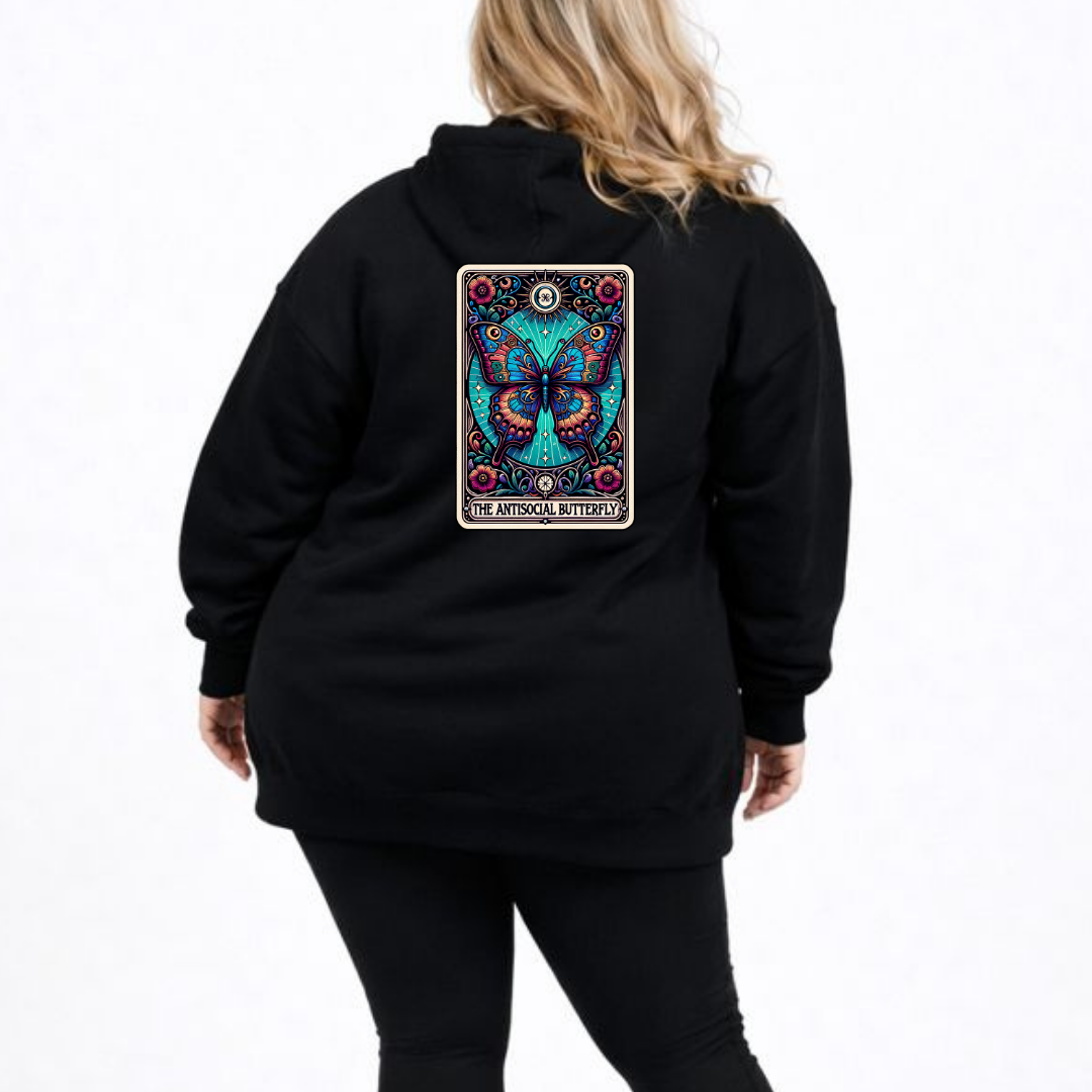 Black hoodie with a colorful butterfly design on the back, worn by a person.