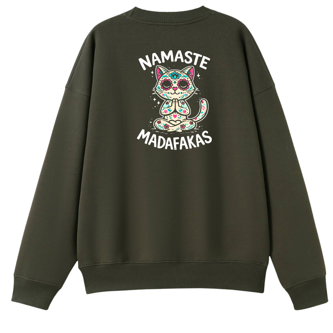 An olive green crewneck sweatshirt shown from the back, featuring a colorful sugar-skull cat graphic with the text 'NAMASTE MADAFAKAS' in white.