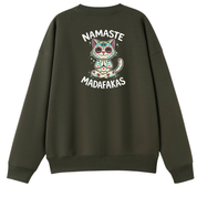 An olive green crewneck sweatshirt shown from the back, featuring a colorful sugar-skull cat graphic with the text 'NAMASTE MADAFAKAS' in white.