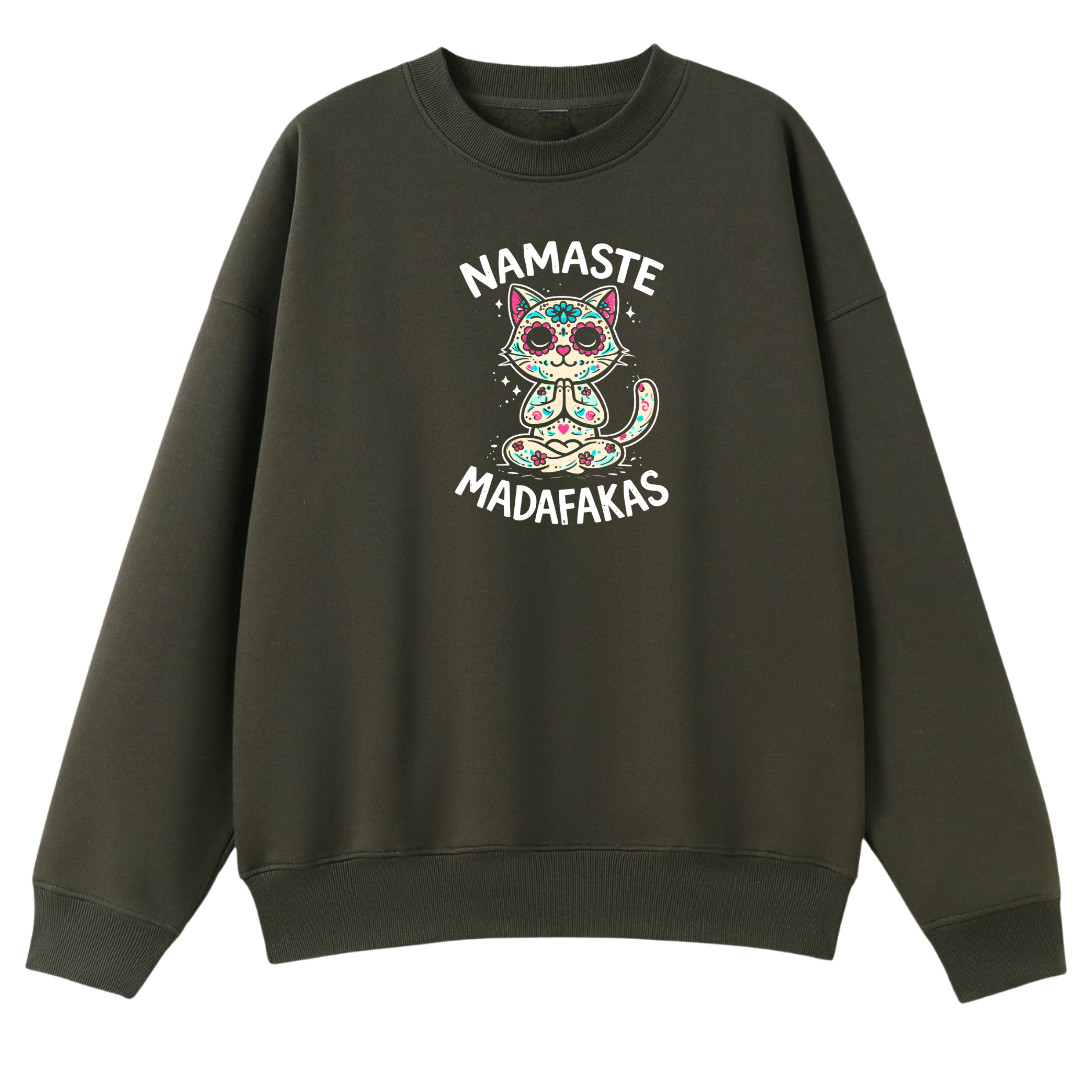 An olive green crewneck sweatshirt featuring a colorful graphic of a meditating cat with 'NAMASTE MADAFAKAS' text on the front, displayed against a solid white background.