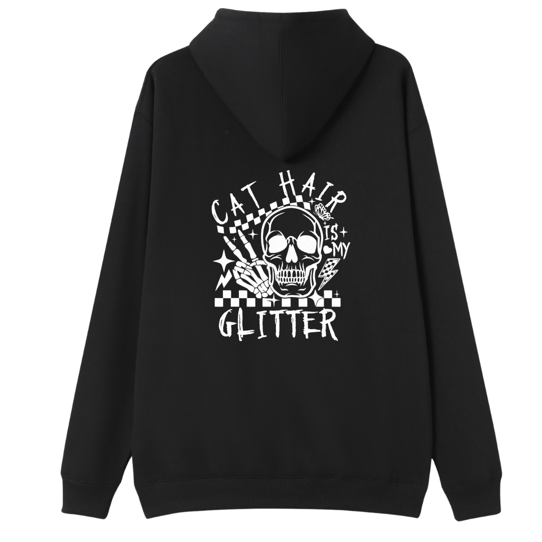 A black pullover hoodie shown from the back, featuring a large white graphic print of a skull with cat ears, checkered details, and the text 'CAT HAIR GLITTER' on a plain white background.
