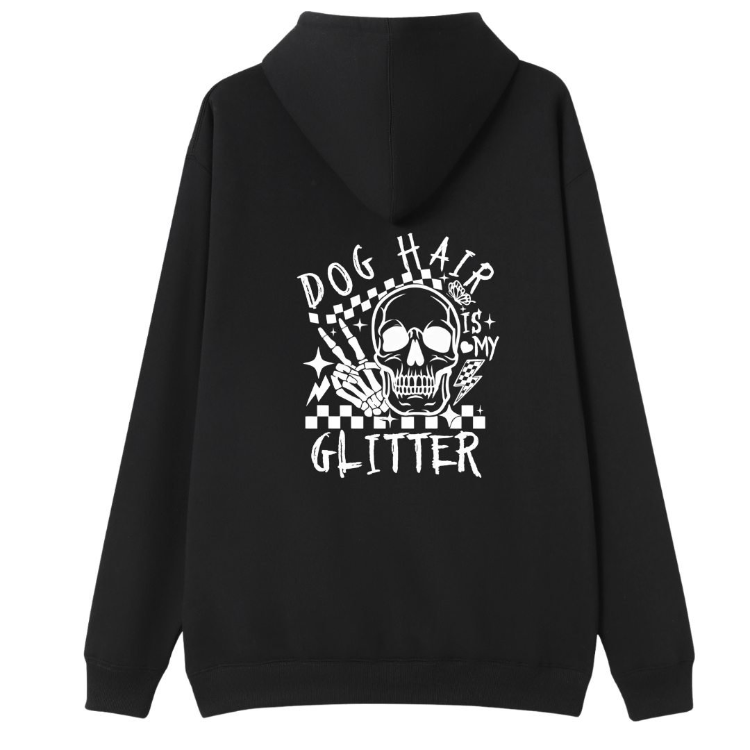 A black pullover hoodie shown from the back, featuring a large white graphic print of a skull, a hand holding a syringe, and the text 'DOG HAIR IS MY GLITTER' on a white background.