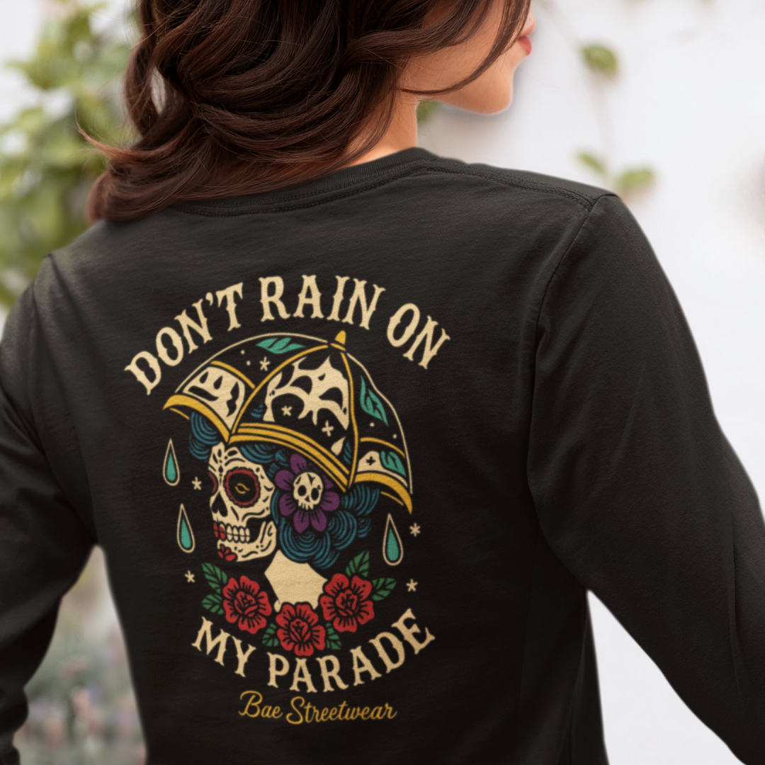 Plus-size black long sleeve tee with cream “Don’t Rain On My Parade” text above a colorful sugar skull wearing an umbrella hat and red rose border – handmade Melbourne streetwear by Bae Streetwear