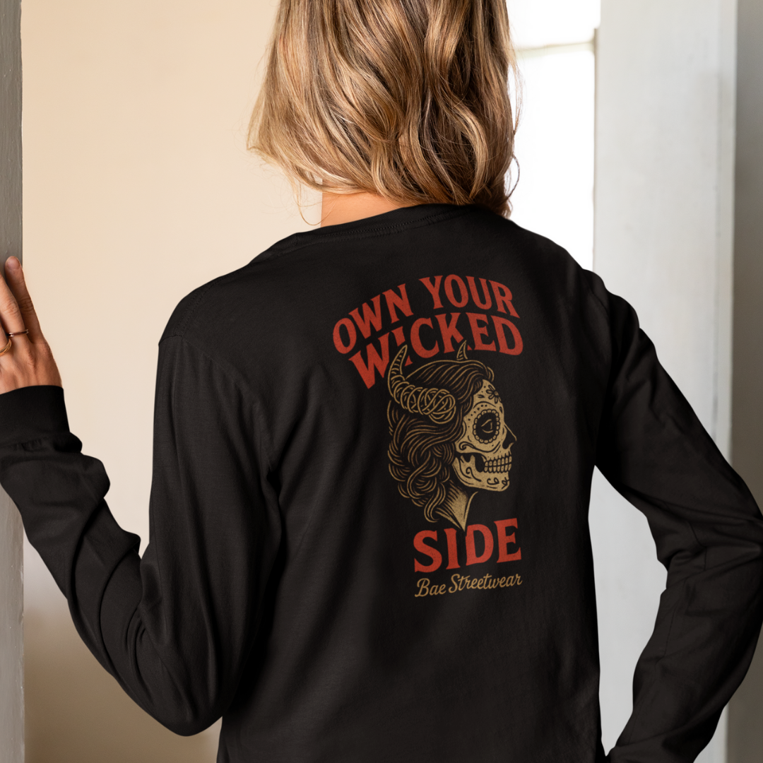 Plus-size black long sleeve tee with red ‘Own Your Wicked Side’ text above devil-horned sugar skull woman graphic – limited-edition Melbourne handmade streetwear by Bae Streetwear