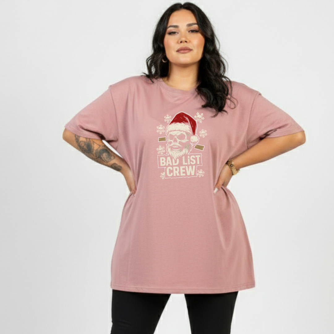 Woman wearing a pink t-shirt with a Christmas design and text on a white background