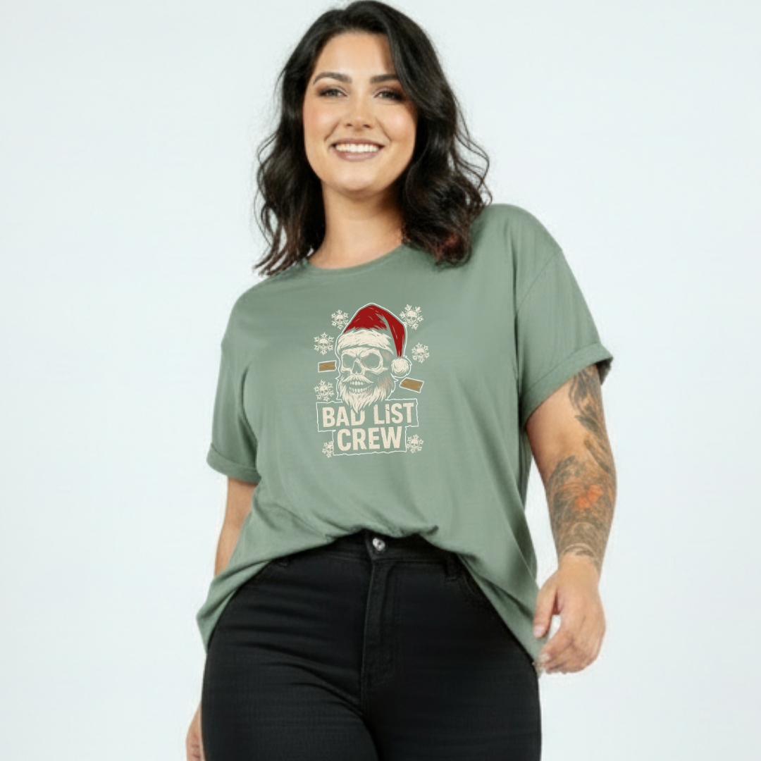 Woman wearing a green t-shirt with a Christmas-themed graphic and text.