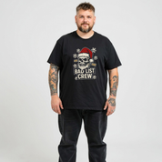 Man wearing a black t-shirt with a graphic design and text on a plain background