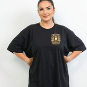 Woman wearing a black t-shirt with a gold graphic design on a white background